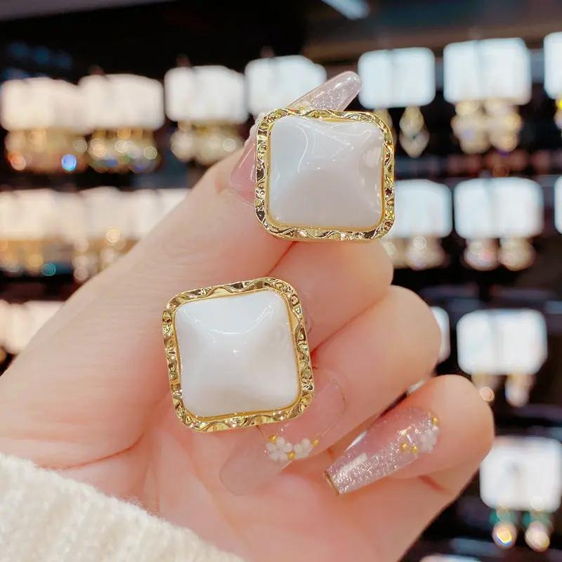 White glossy square stud earrings, textured gold frame | Hair Your Lux