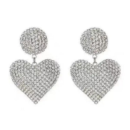 Crystal heart drop earrings worn, silver-tone statement piece | Hair Your Lux