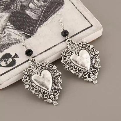 Ornate silver sacred heart drop earrings with black bead | Hair Your Lux