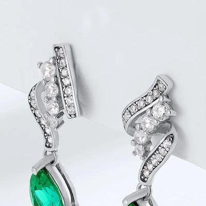 Pear-cut green stone drop earrings on pavé twist | Hair Your Lux