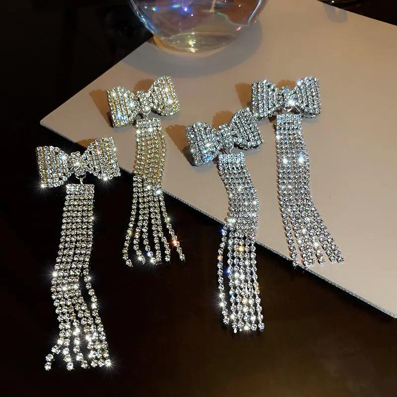 Crystal bow earrings with long rhinestone fringe, silver-tone | Hair Your Lux