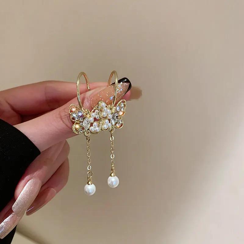 Gold-tone crystal butterfly earrings with pearl-style tassel drops | Hair Your Lux