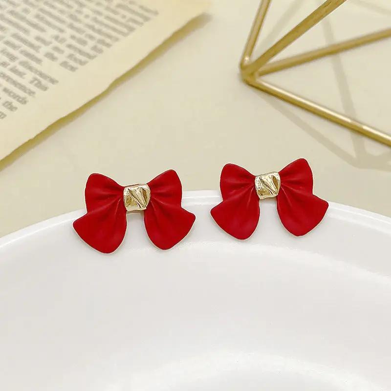 Bow stud earrings, matte black with gold knot | Hair Your Lux