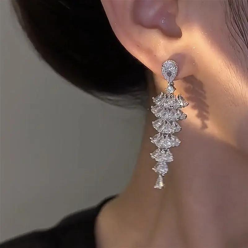 Cubic zirconia fir chandelier drop earrings on ear | Hair Your Lux