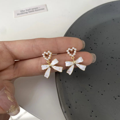 Pearl heart bow studs worn, silver-tone | Hair Your Lux
