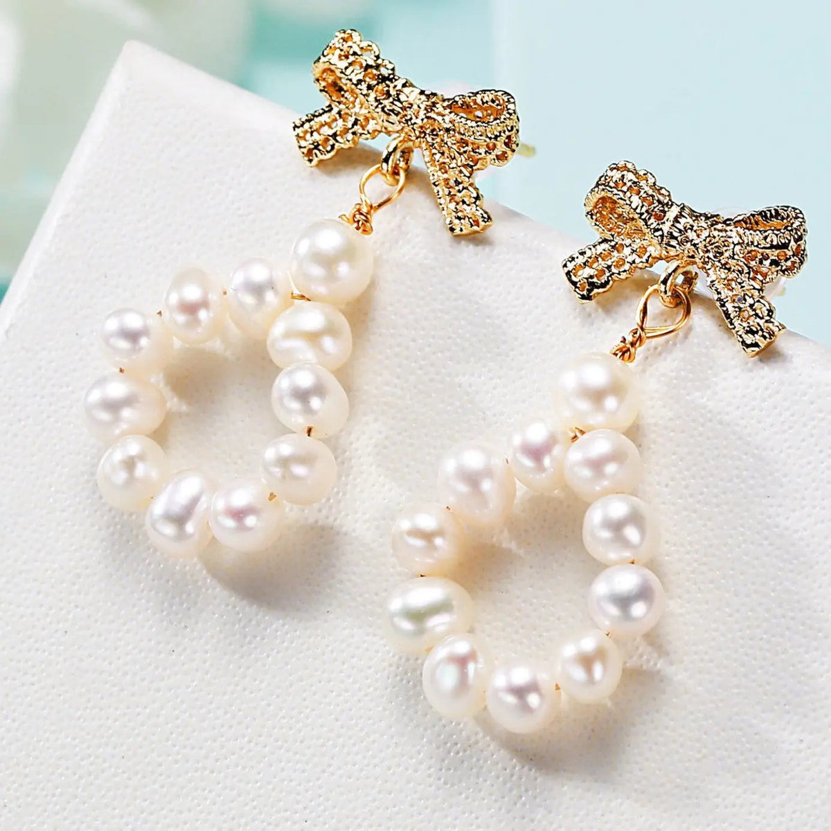 Gold bow and freshwater pearl loop drop earrings | Hair Your Lux