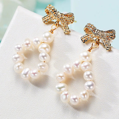 Gold bow and freshwater pearl loop drop earrings | Hair Your Lux