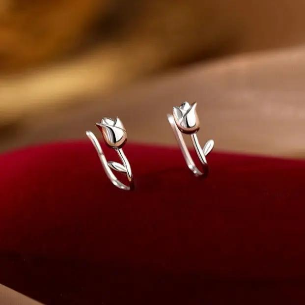 Silver tulip flower stem earrings on ear | Hair Your Lux